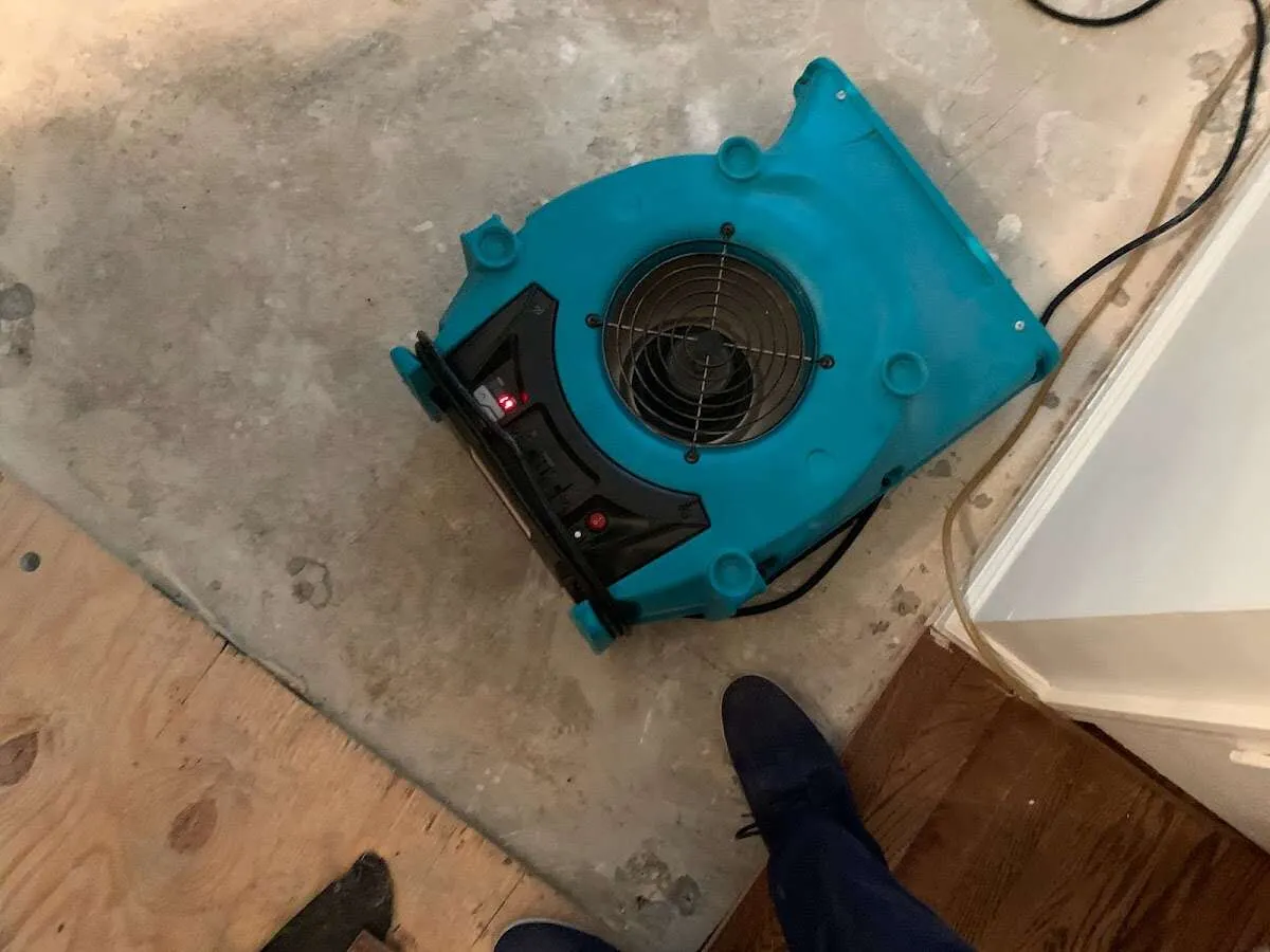 Air mover drying subfloor during Leak Detection & Repair in Americus